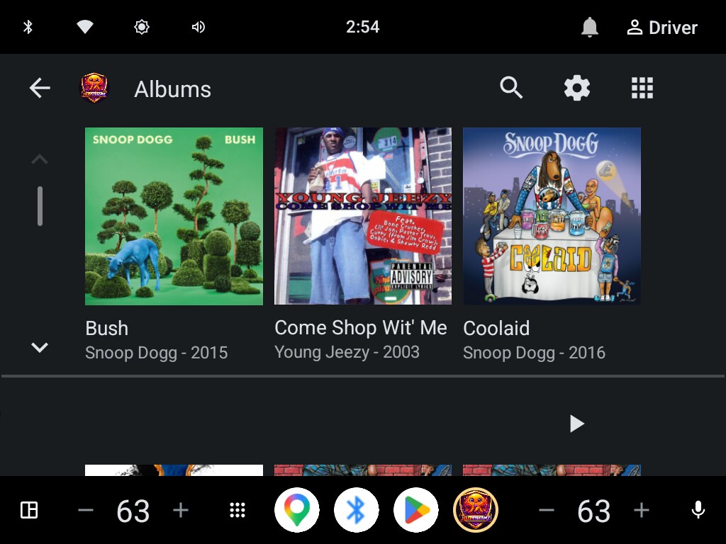 Android Automotive album browser showing square album art, album titles, and artists